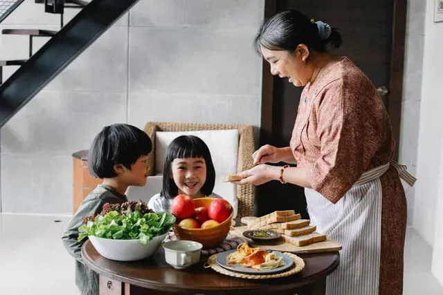 Grandparents outdoors with their grandchildren.
